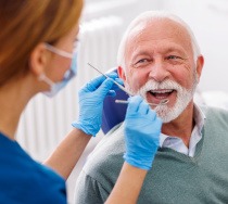 Mature man smiling during dental checkup