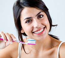 dentist looking at patient’s teeth 