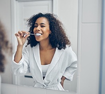 SureSmile patient in New Bedford brushing their teeth